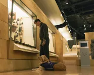 Tactile tour at the ROM.
 A person with service dog enjoy ROM