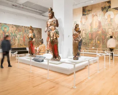 A spacious museum displays a large painting of Buddhas on the wall, highlighting their peaceful expressions and rich symbolism. A spacious museum displays a large painting of Buddhas on the wall, highlighting their peaceful expressions and rich symbolism.