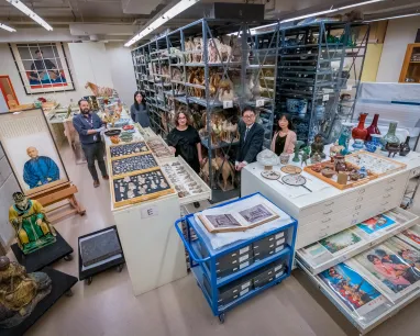 A diverse group of visitors exploring a museum filled with various artifacts and exhibits. A diverse group of visitors exploring a museum filled with various artifacts and exhibits.