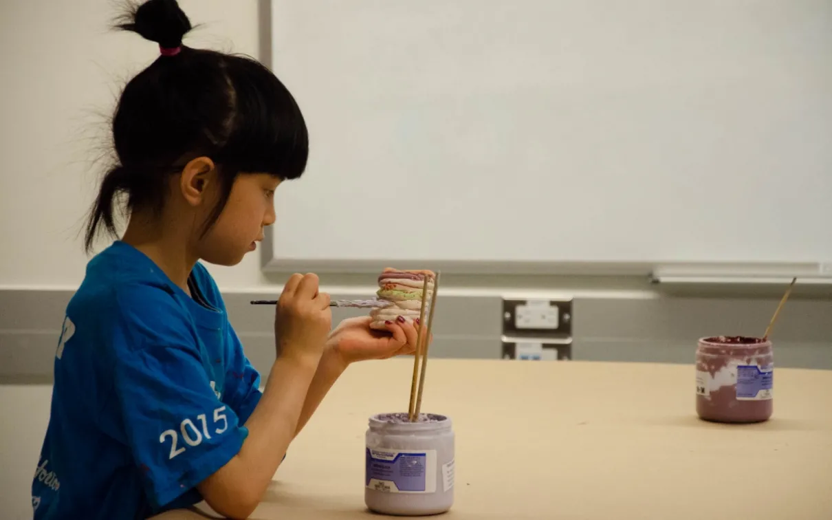 A student paints her ceramic pot in class. Image: Michael Berger A student paints her ceramic pot in class. Image: Michael Berger