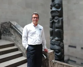 A man posing at the bottom of a stair case. A man posing at the bottom of a stair case.