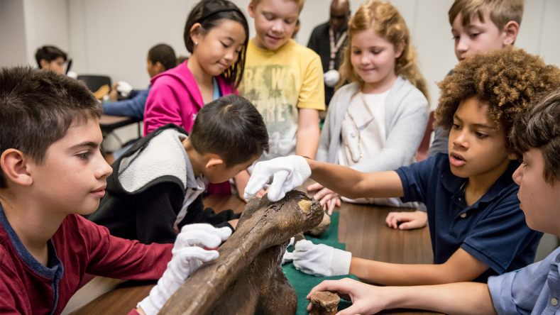 Kids with fossil bone