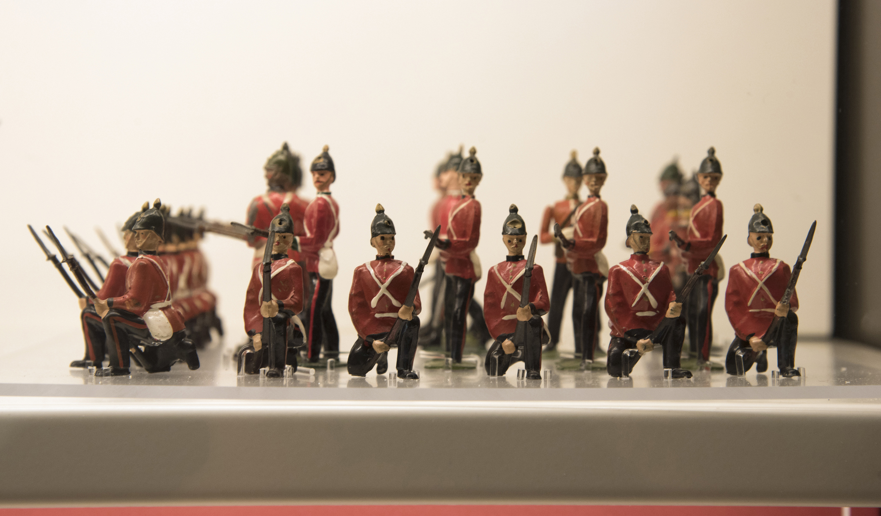 Close-up of a group of toy soldiers in red jackets standing in formation