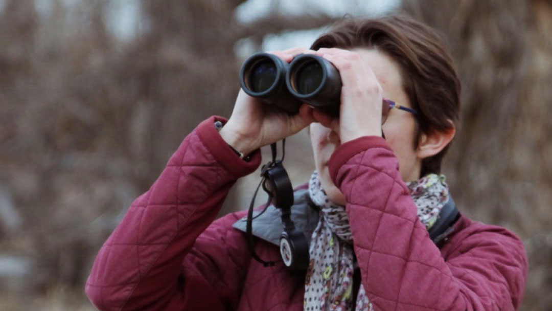 Woman looking through binoculars