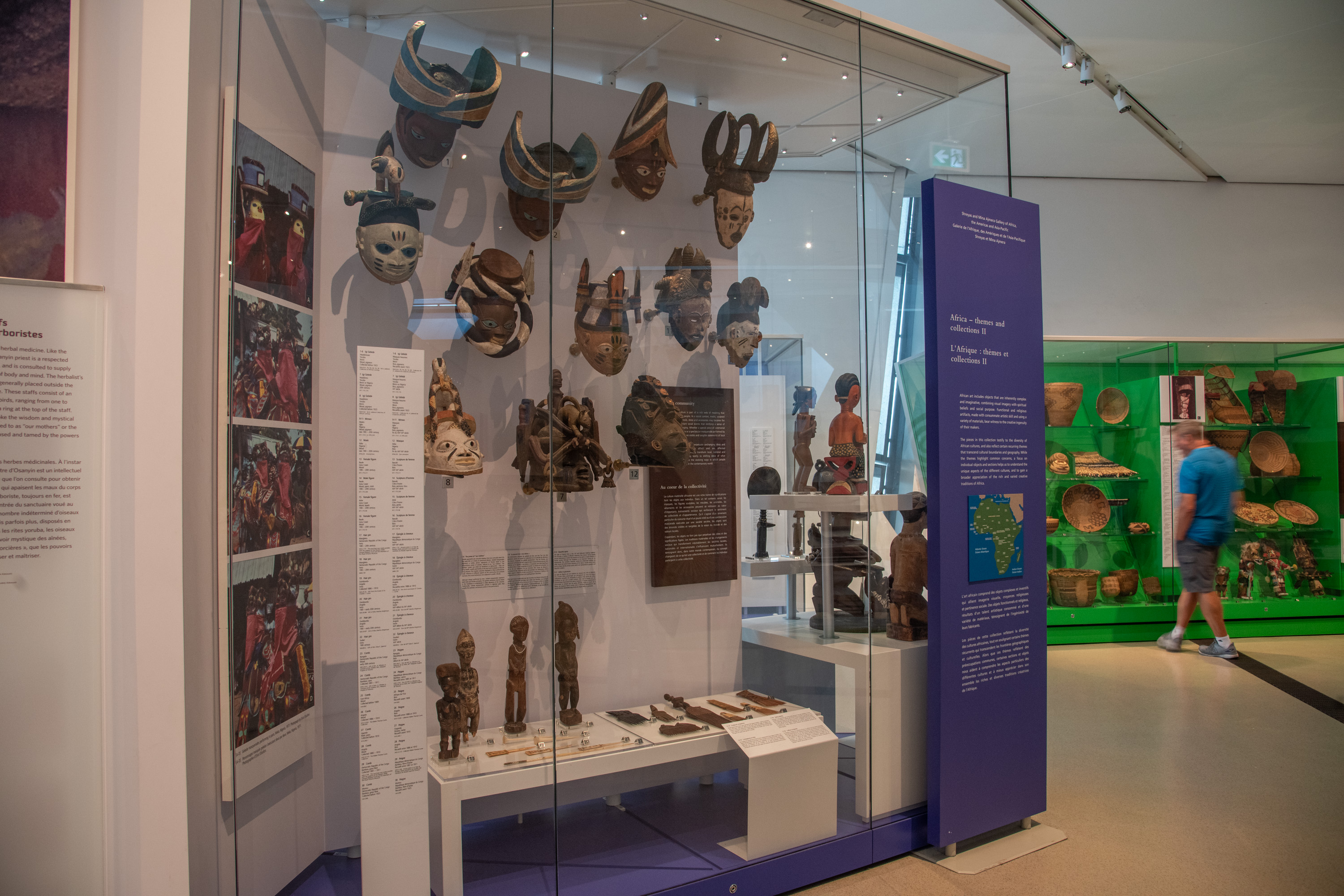 A man looks at an object in a green case, in the foreground you can see masks.