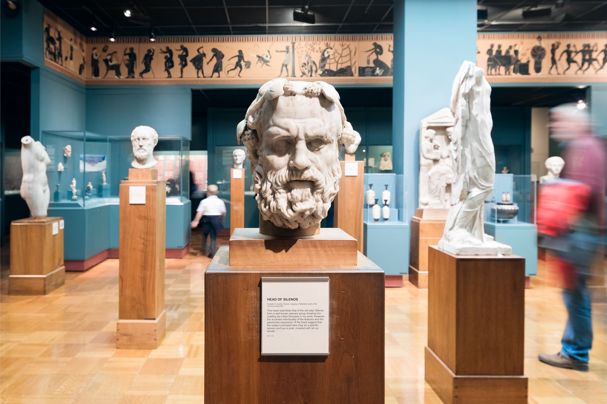 The stern face of Silenos carved in marble stares