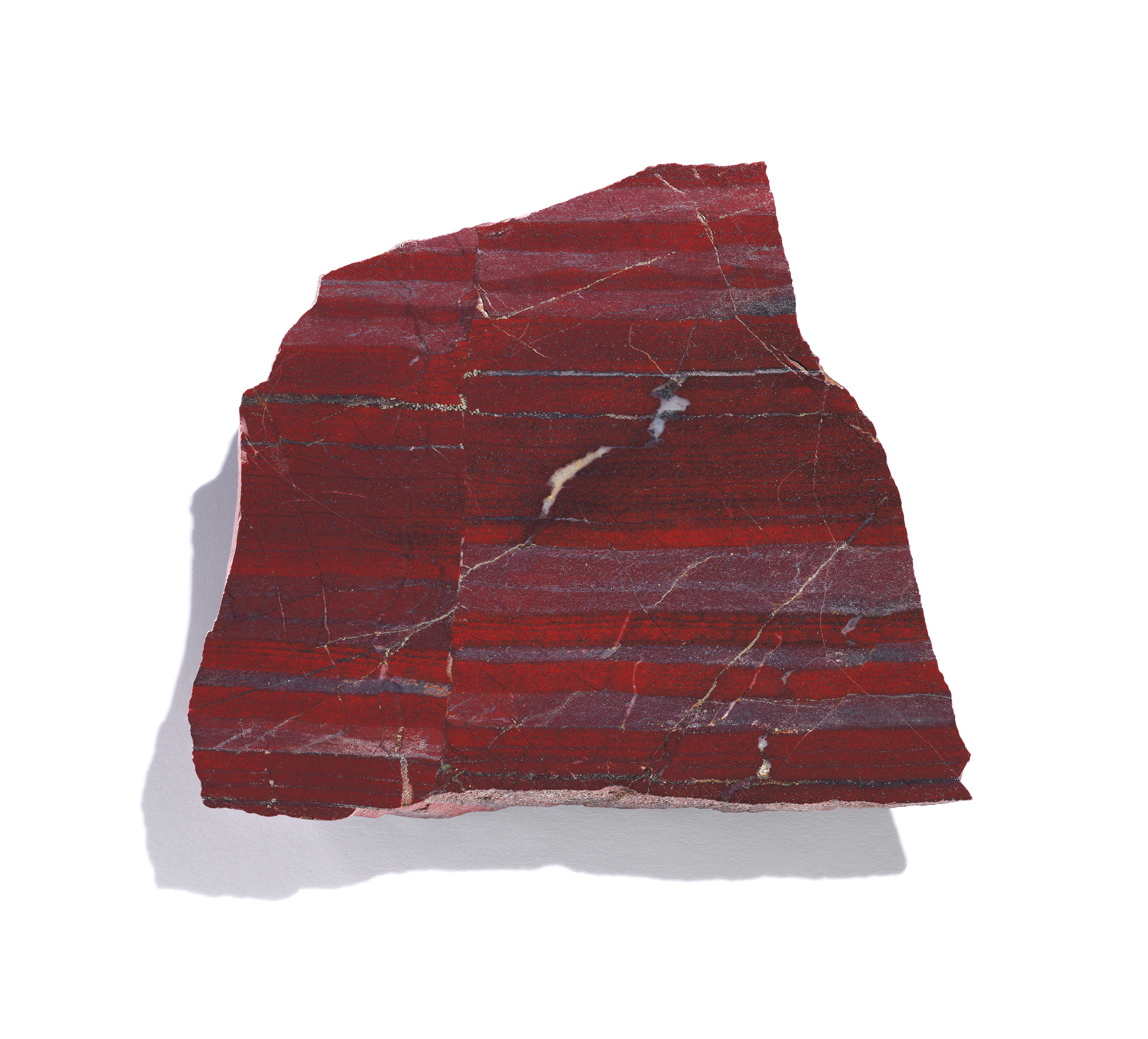 Slice of red banded mineral with shadow