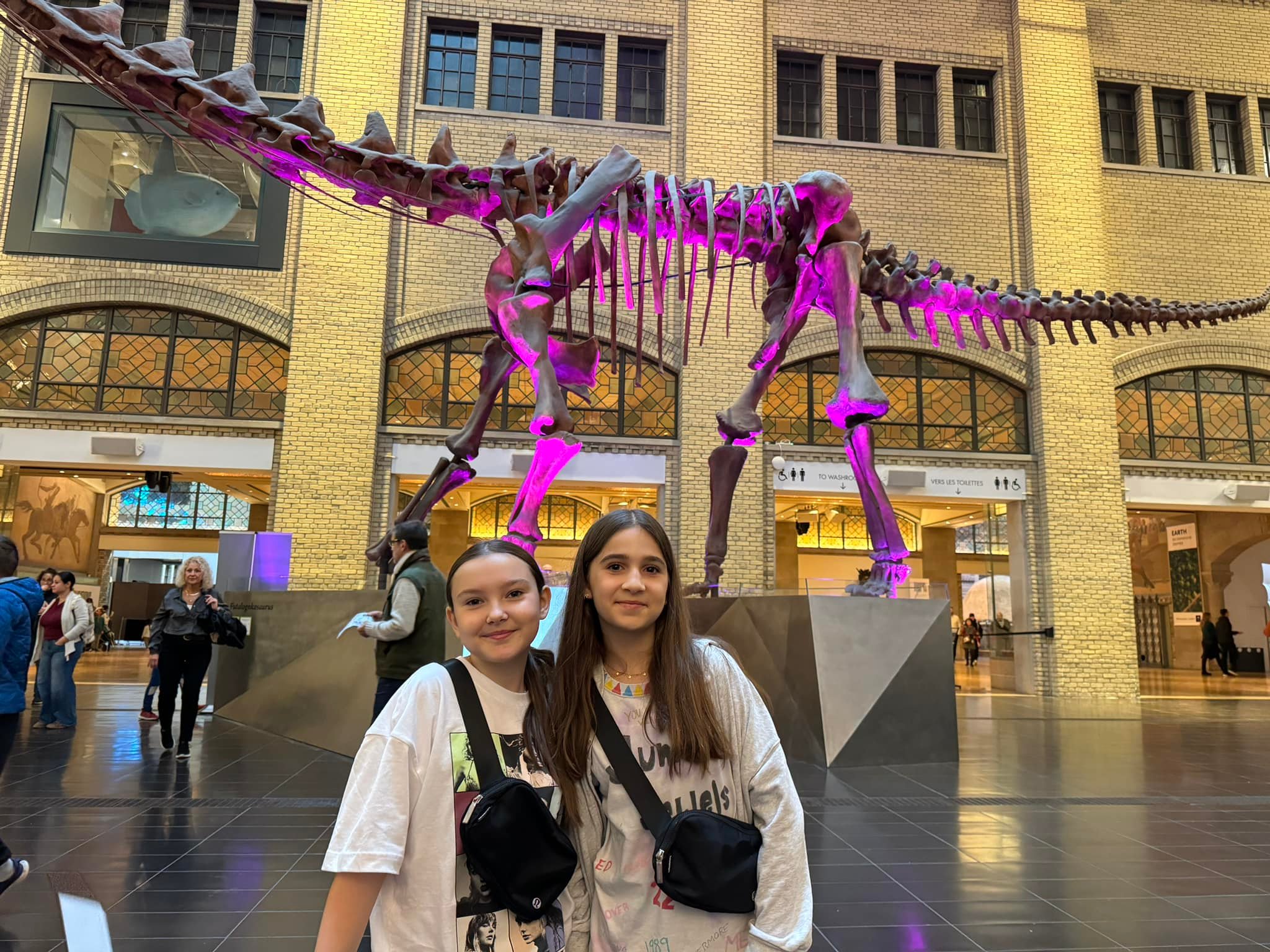 Two Swift Fans Pose in Front of ROM's Futalognkosaurus