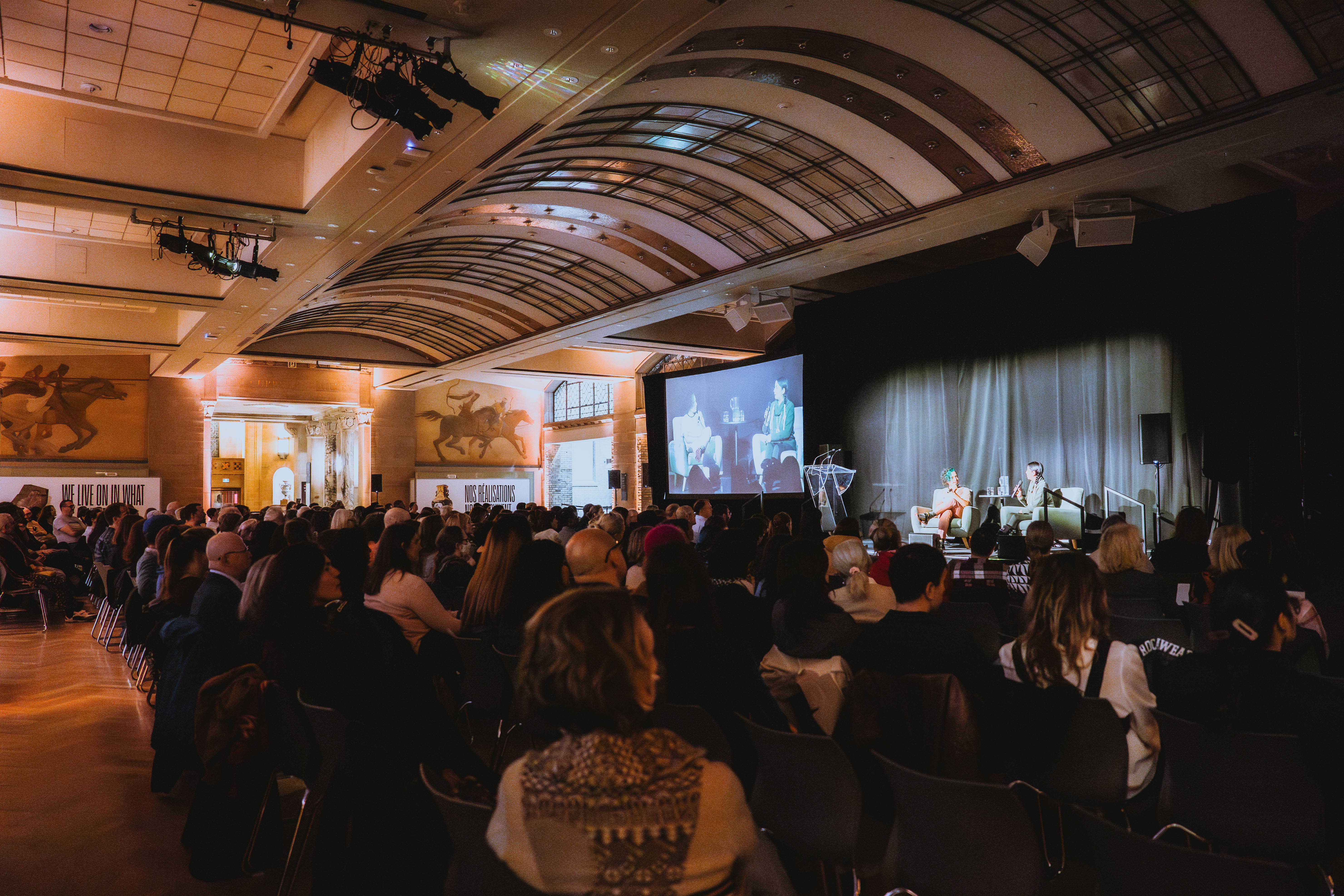 Crowd of people sitting at a ROM Speaks event