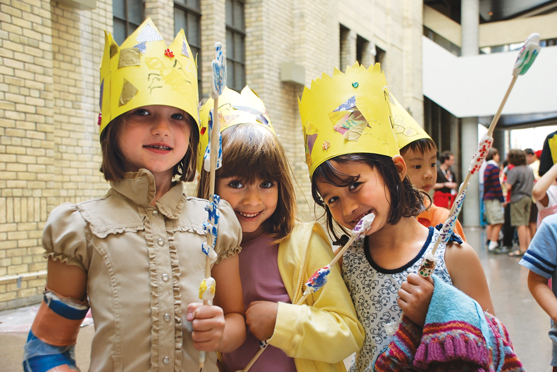 3 children with crowns enjoying birthday party celebrated at ROM