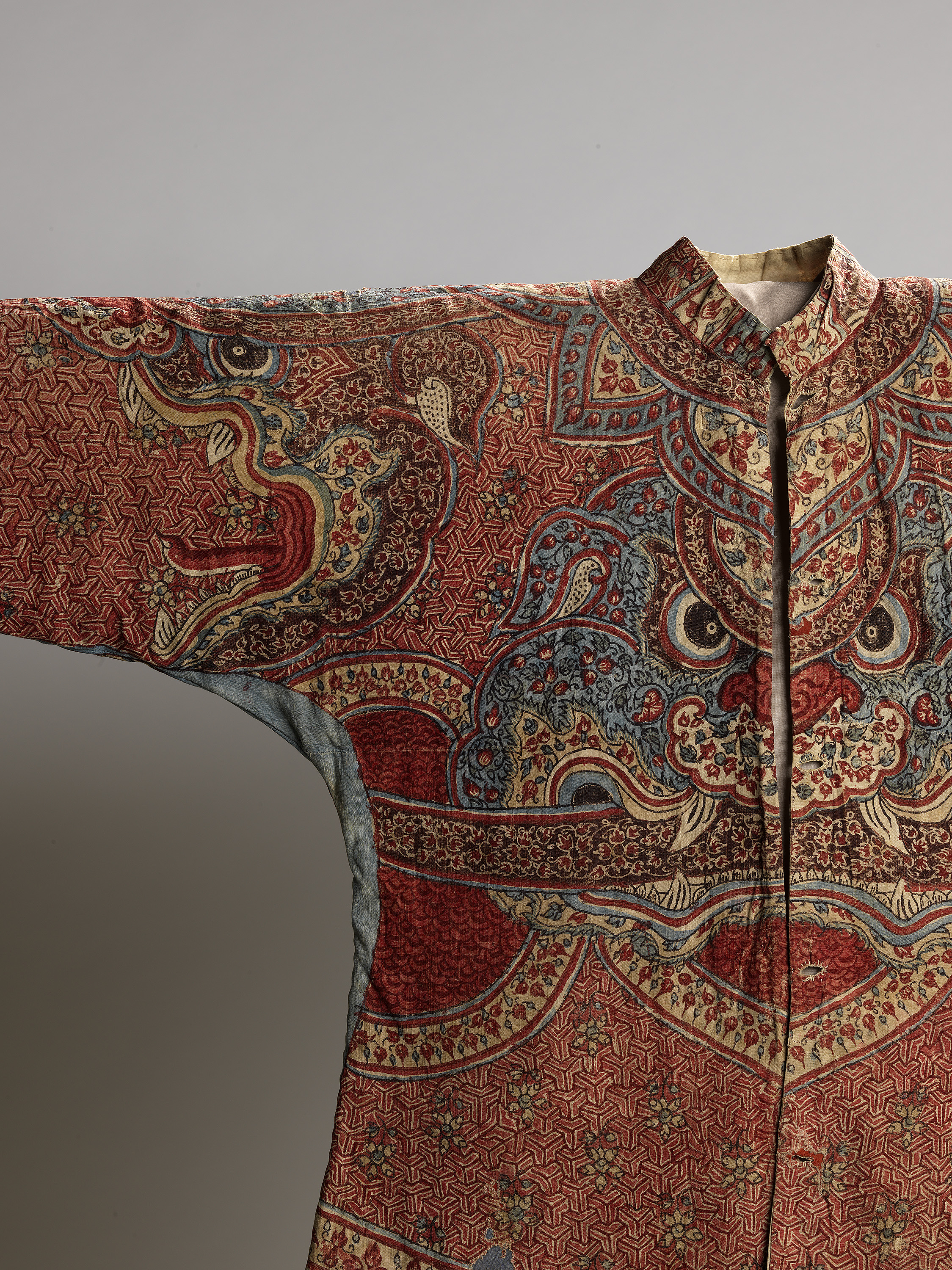 A beautifully designed oriental jacket adorned with a dragon motif on the front, reflecting traditional craftsmanship and artistry.