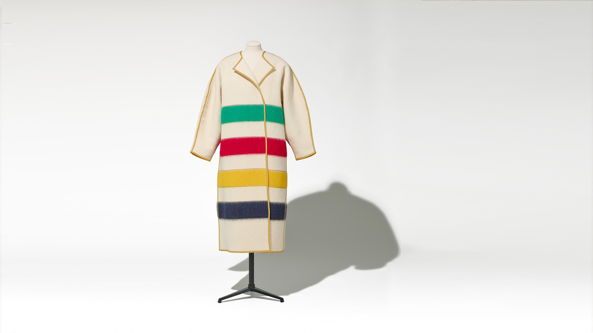 A coat featuring vibrant multicolored stripes, showcasing a stylish and eye-catching design.