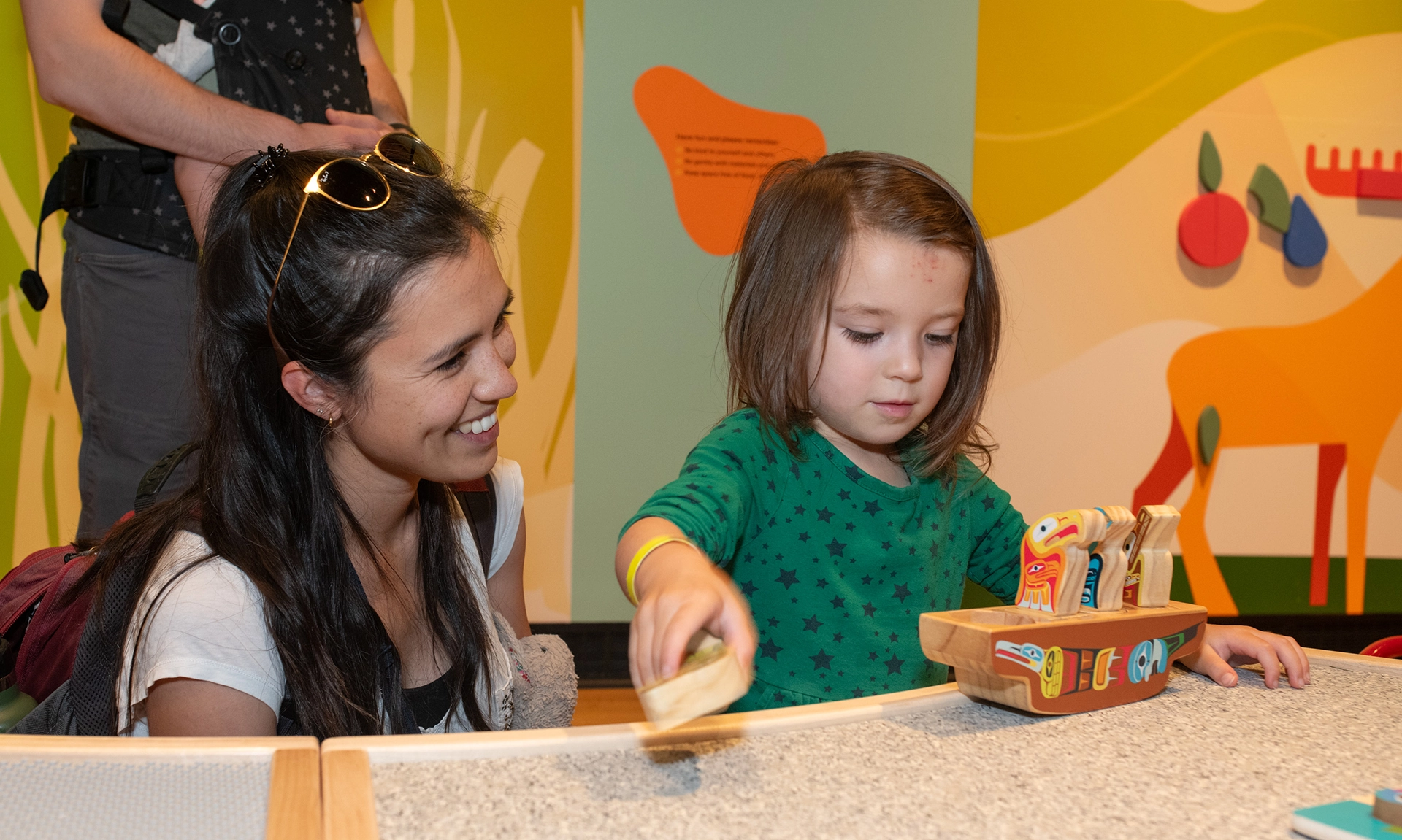 Child enjoying ROM Kids Junior program with parent watching