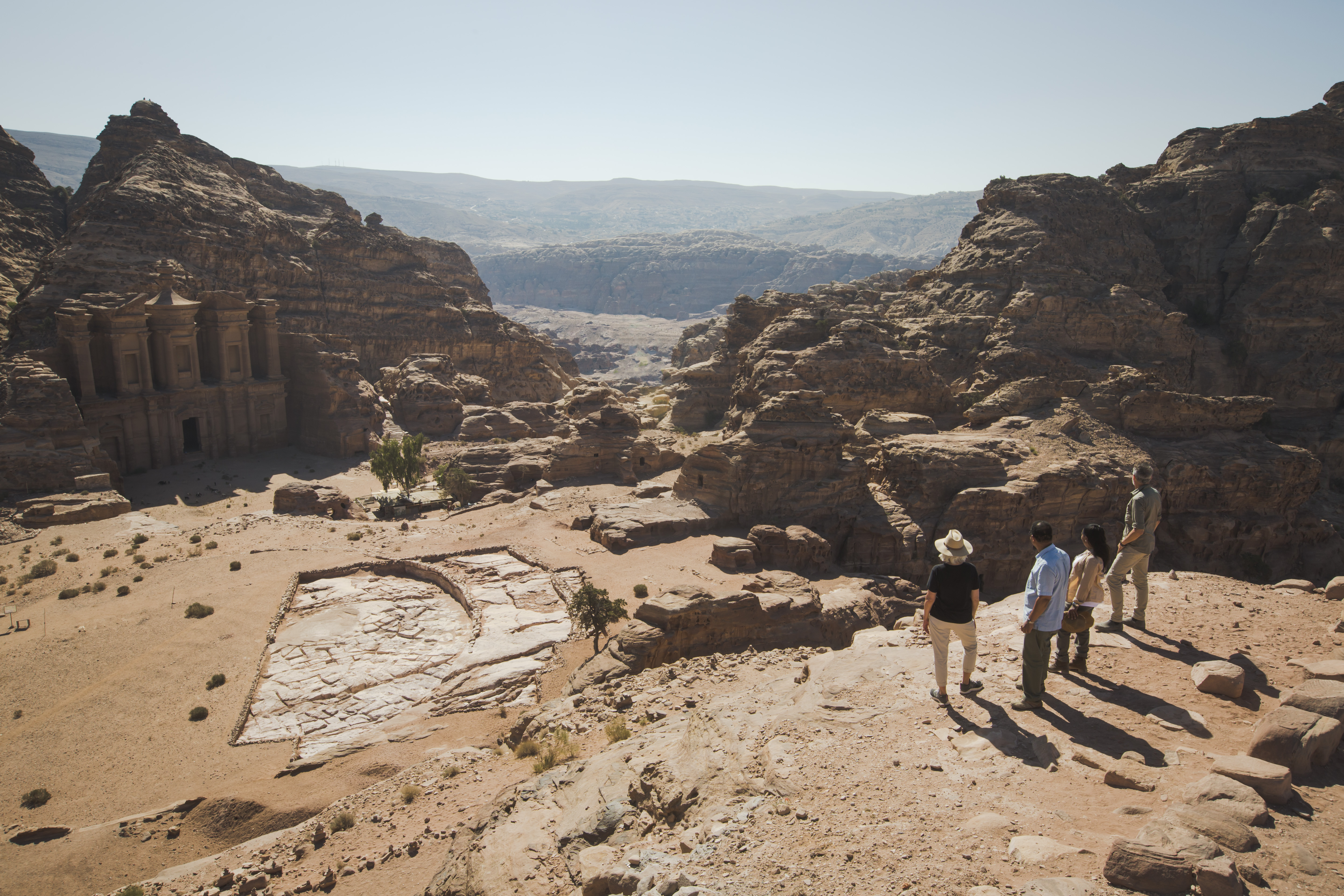 A girl sits on the side of the walkway at the Jordan Petra Monastery