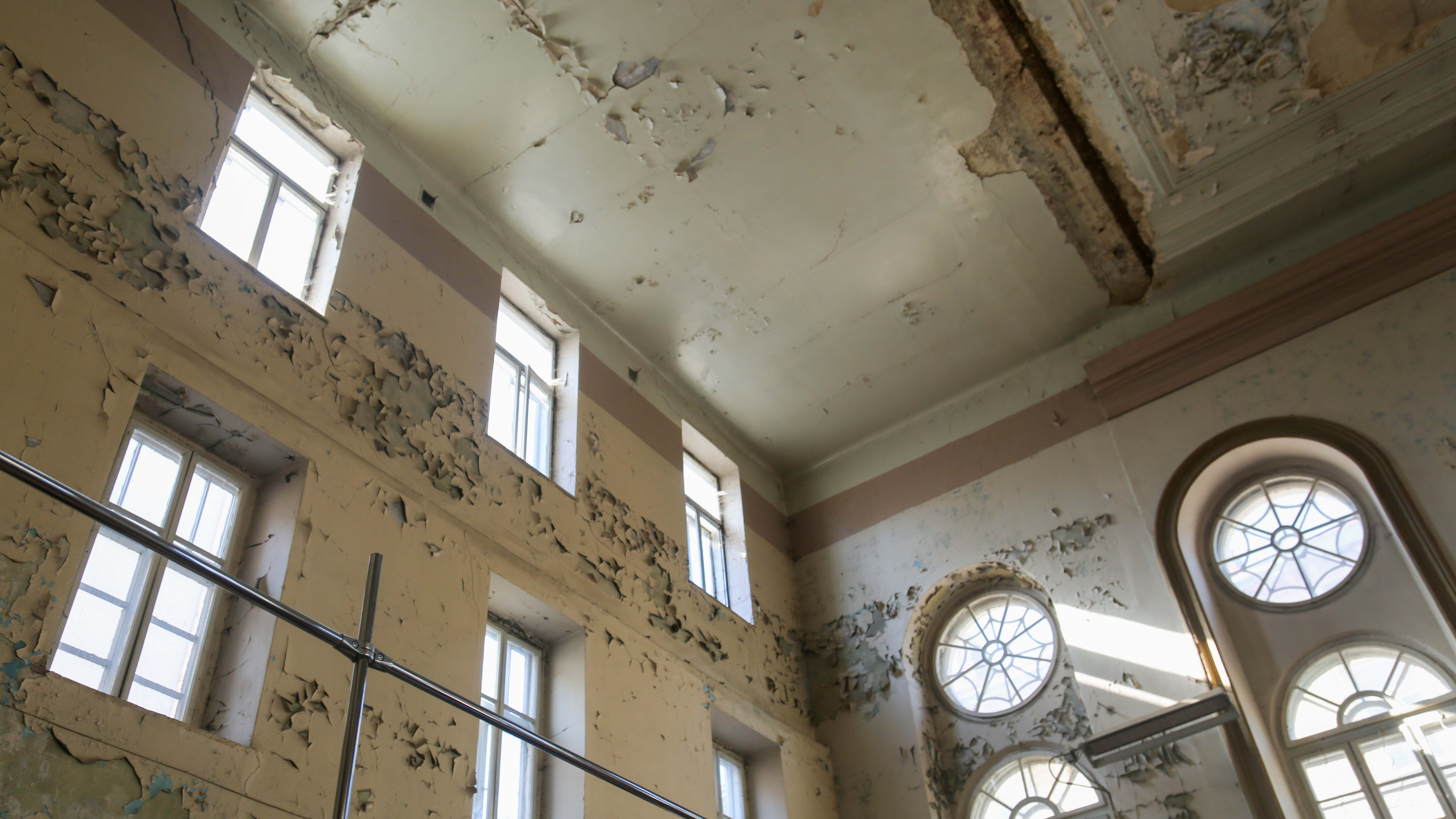  building's deteriorating interior wall and ceiling.