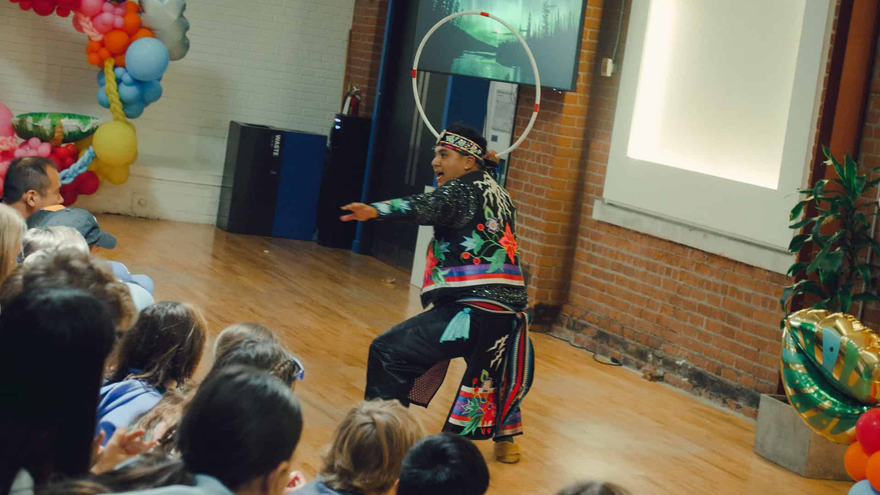 Nimkii Osawamick performing a Hoop Dance