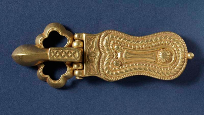 Ornate jewelry and church frescoes are showcased, such as this 7th century gold belt buckle.