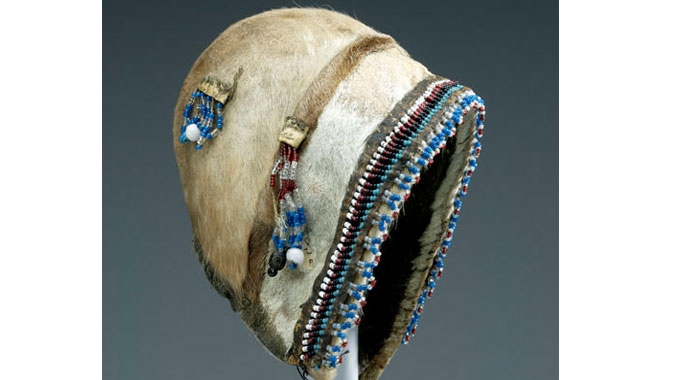 Robert J. Flaherty (1884-1951) was commissioned by the Canadian Northern Railway to find iron-ore deposits along the northeast coast of Hudson Bay. He visited the Arctic over several years and collected a wide range of Inuit artifacts, such as this child's summer bonnet made of caribou skin decorated with beadwork.