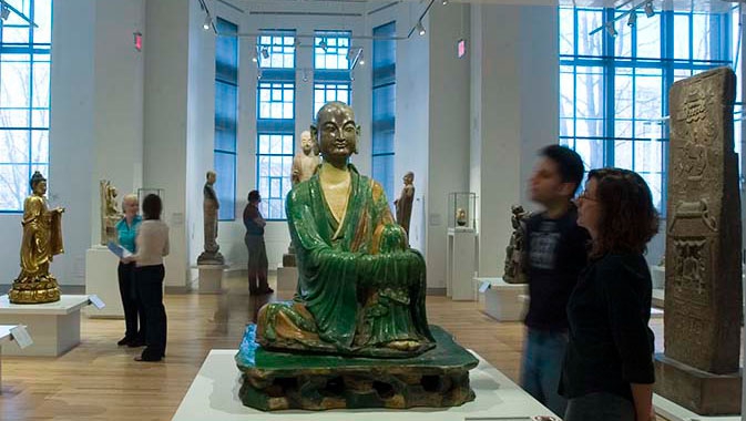 A green glazed ceramic Yizhou Luohan statue from the 10th century sits serenely at the gallery's entrance.