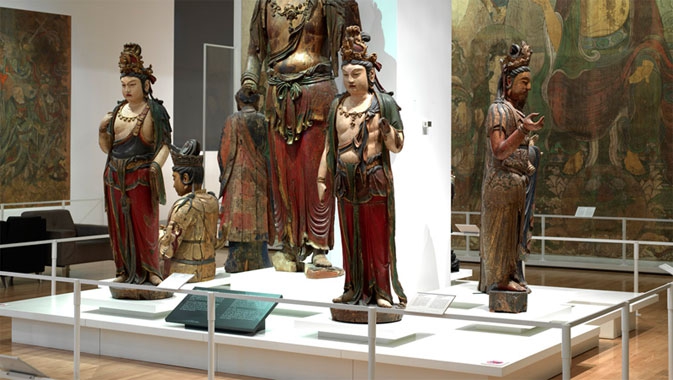 Bishop White Gallery of Chinese Temple Art, showing wooden Buddhist sculptures and wall murals in the ROM gallery