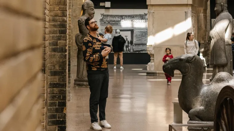 Father and baby standing in the Royal Ontario Museum