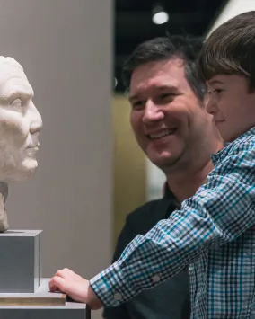 Father and son enjoying ROM sculpture