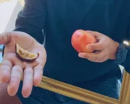 Kiron Mukherjee holding an apple.
