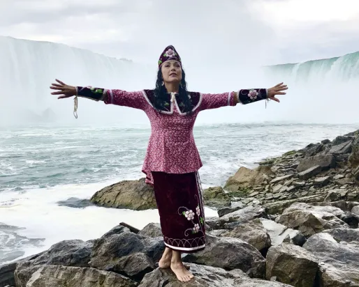 Woman standing in front of Niagara Falls