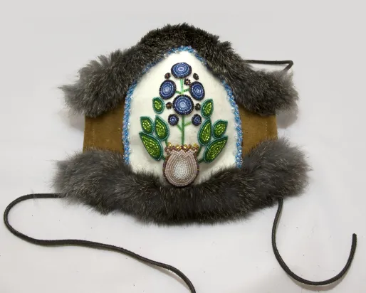 A mask created with beeds in the shape of a blue berry
