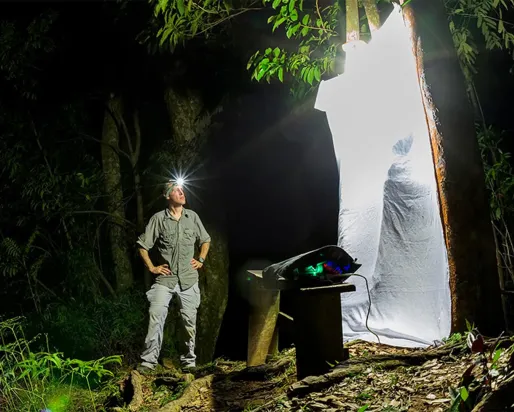 Gil Wizen standing next to an insect trap.