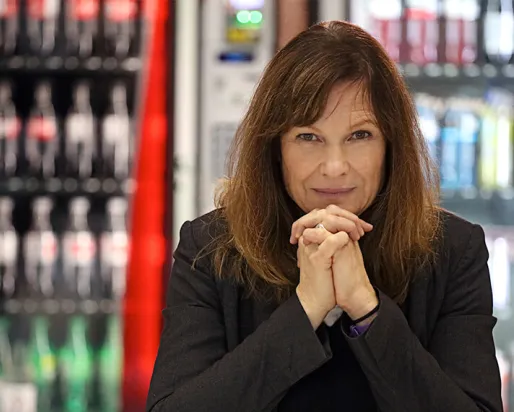 Myra J. Hird in front of a bookshelf.
