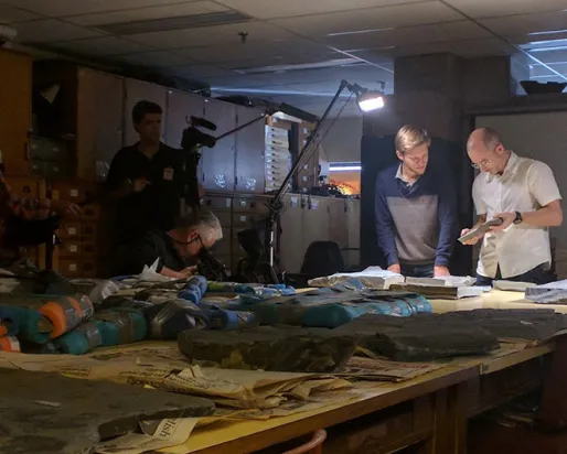 Group of people looking at a fossil