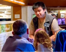 Volunteer speaking to a group of visitors in the Hands On Gallery