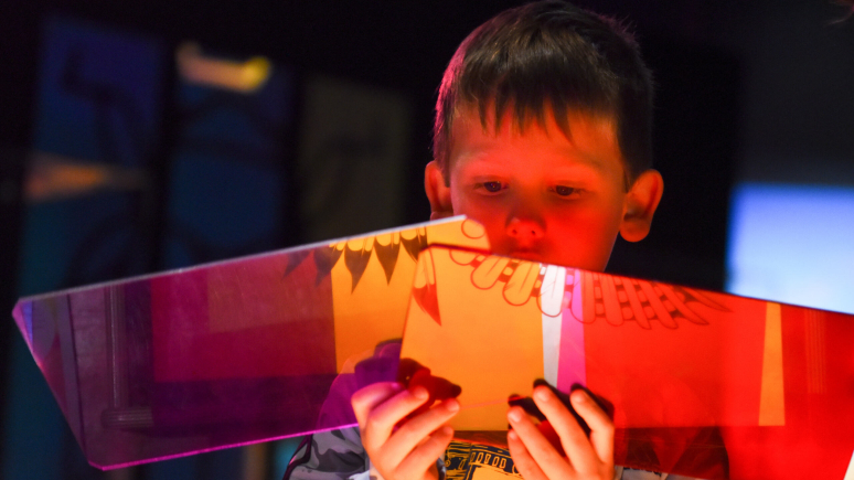 Kid holding colourful object