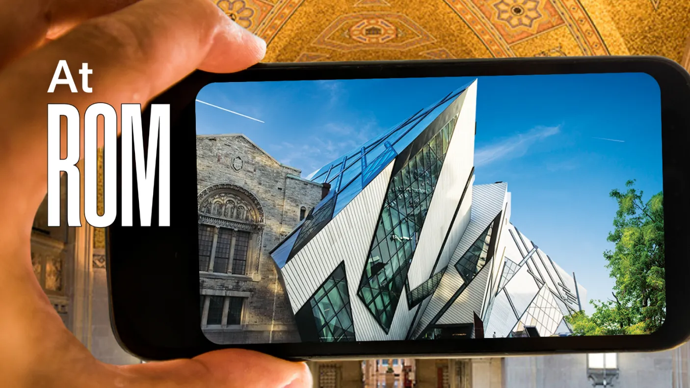 A hand holds a phone whose screen displays an image of the Royal Ontario Museum. At ROM is written next to the phone