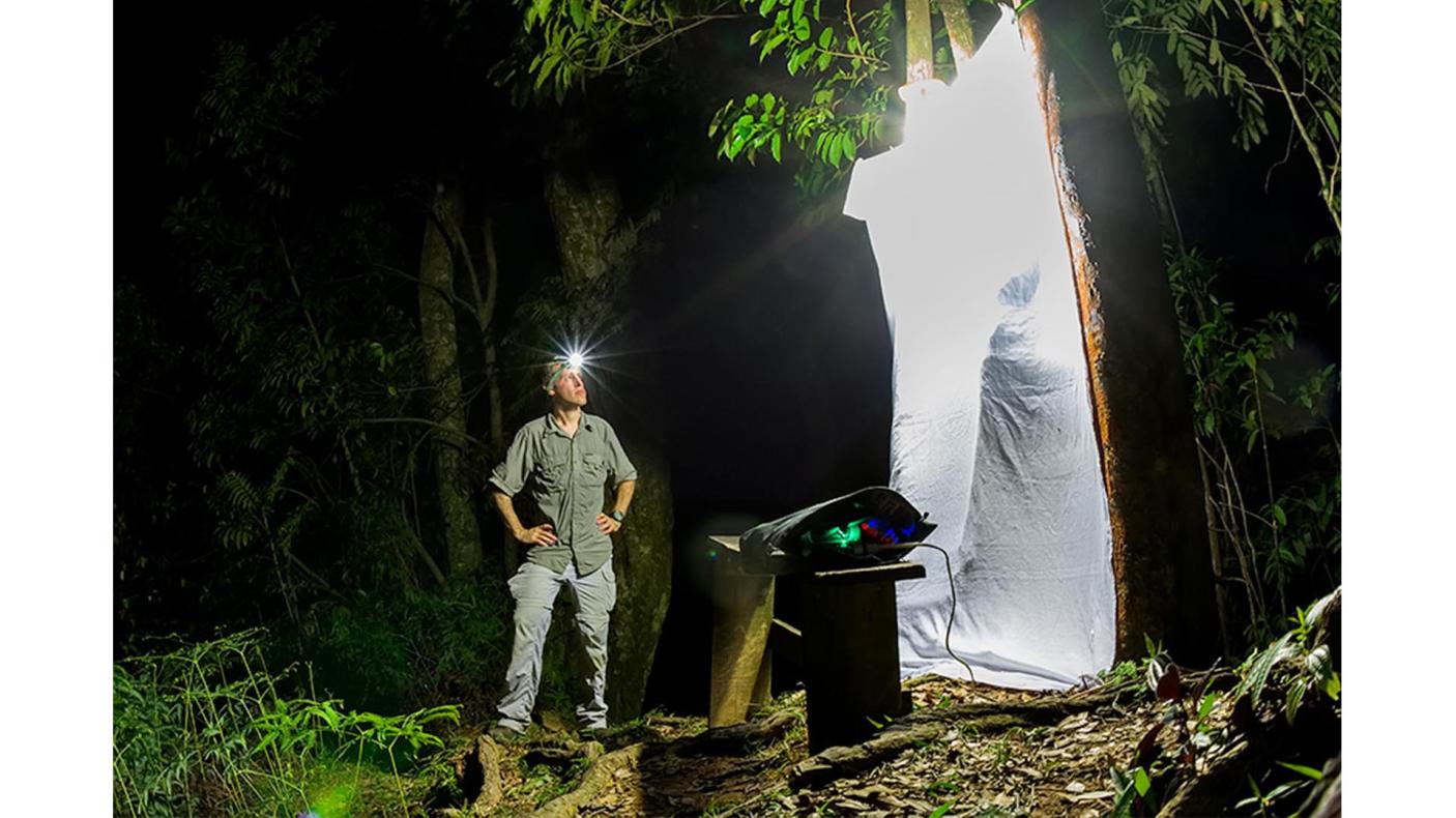 Gil Wizen standing next to an insect trap.