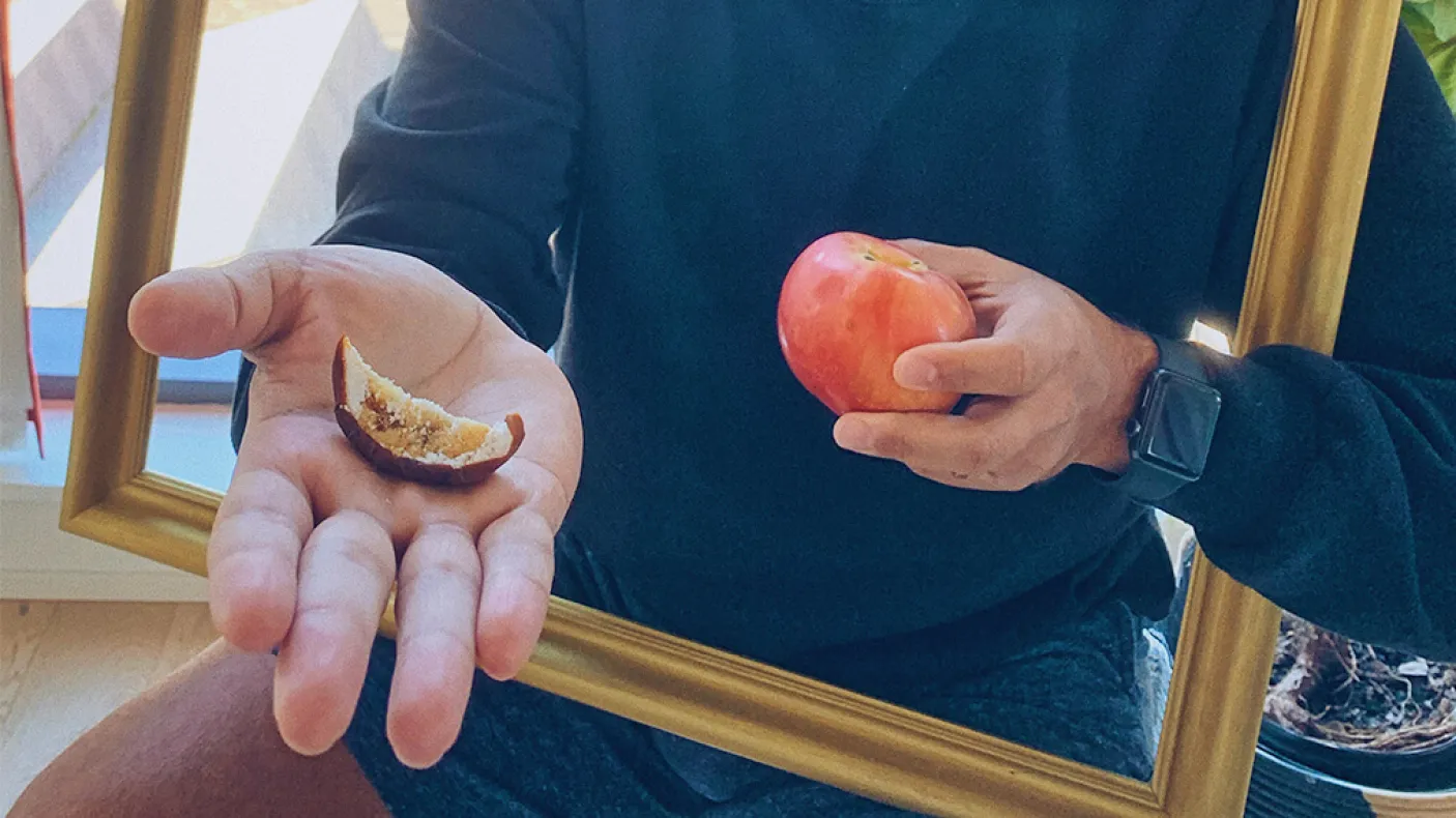 Kiron Mukherjee holding an apple.
