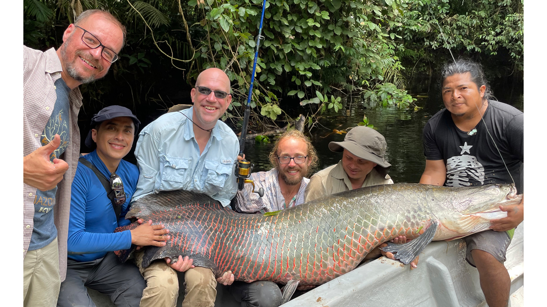 The crew is all smiles as they display their big catch—a two-metre, 200-pound Arapaima. 