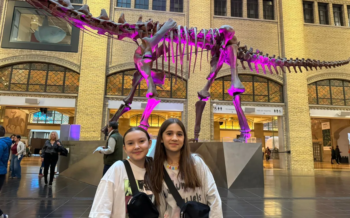 Two Swift Fans Pose in Front of ROM's Futalognkosaurus