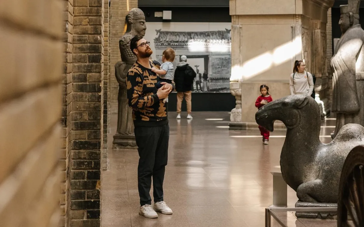 Father and baby standing in the Royal Ontario Museum