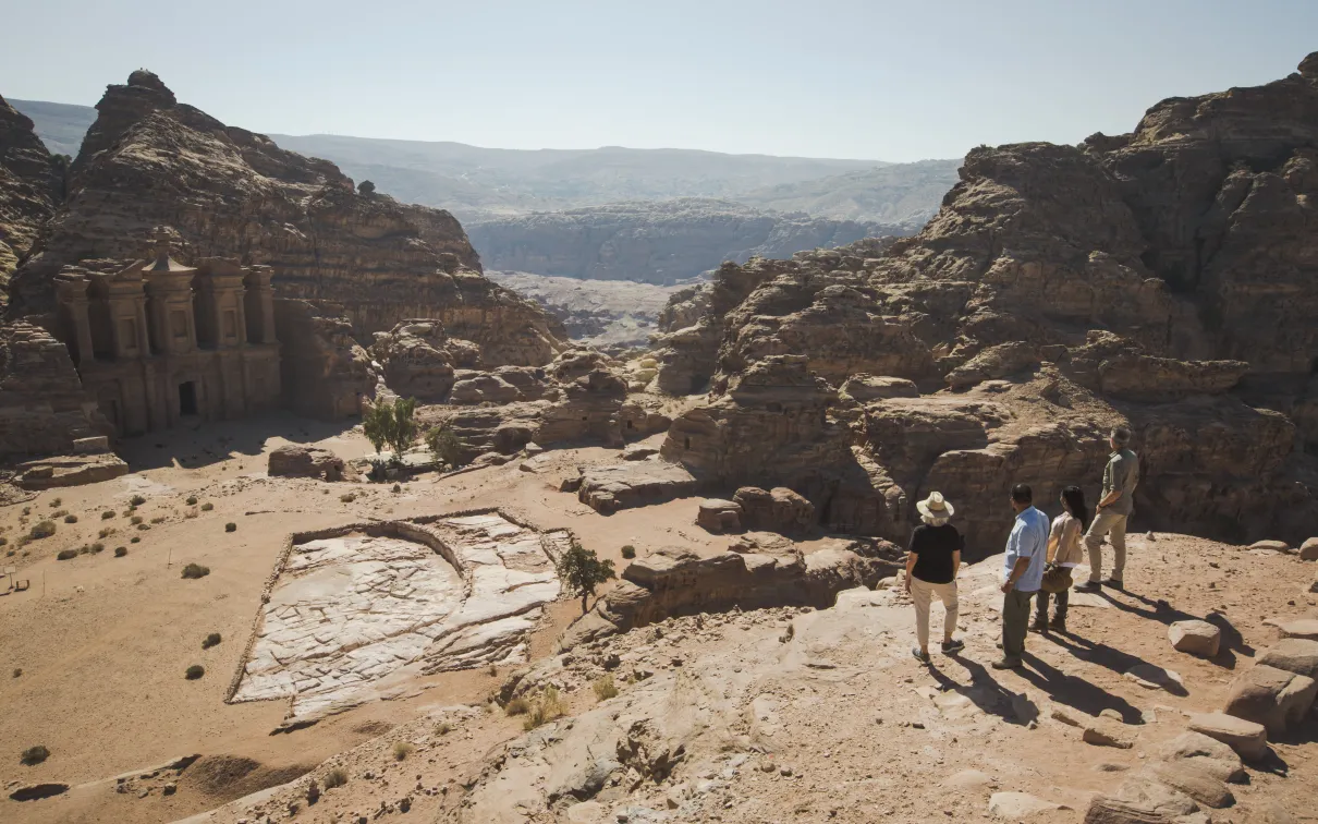 A girl sits on the side of the walkway at the Jordan Petra Monastery