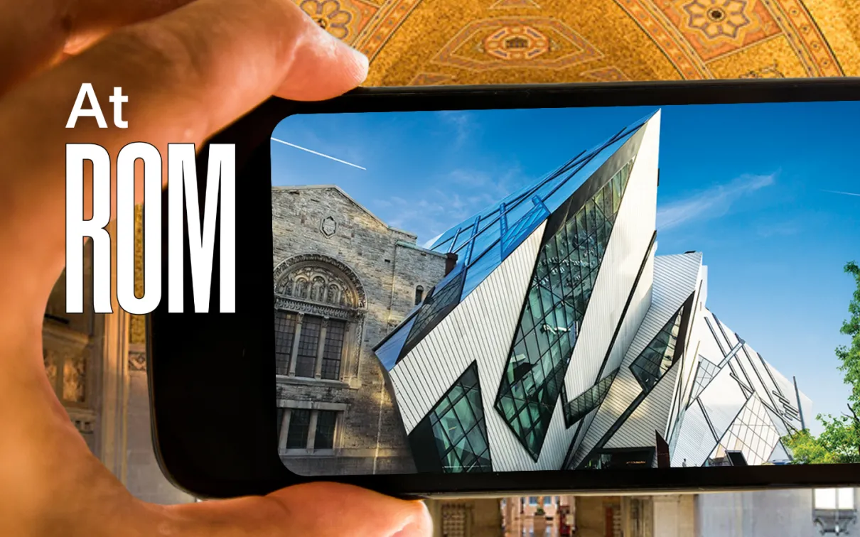 A hand holds a phone whose screen displays an image of the Royal Ontario Museum. At ROM is written next to the phone
