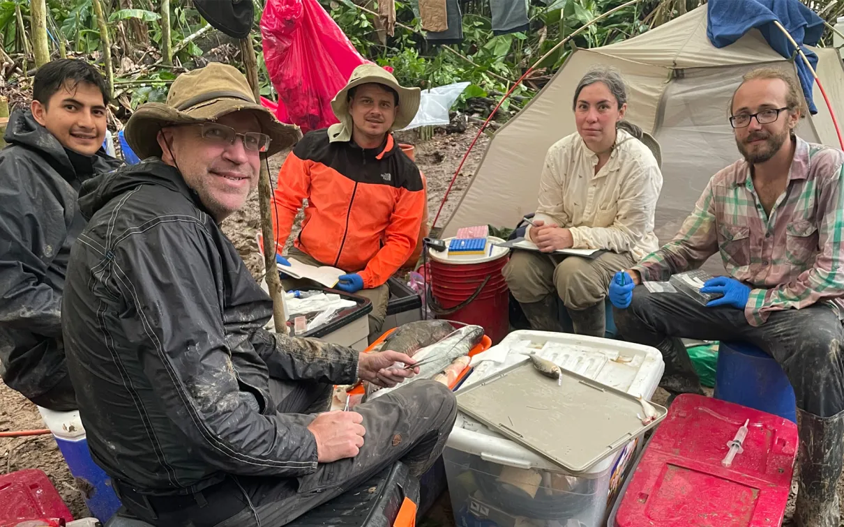 Sitting on buckets and boxes, Lujan and colleagues process an array of fresh specimens.