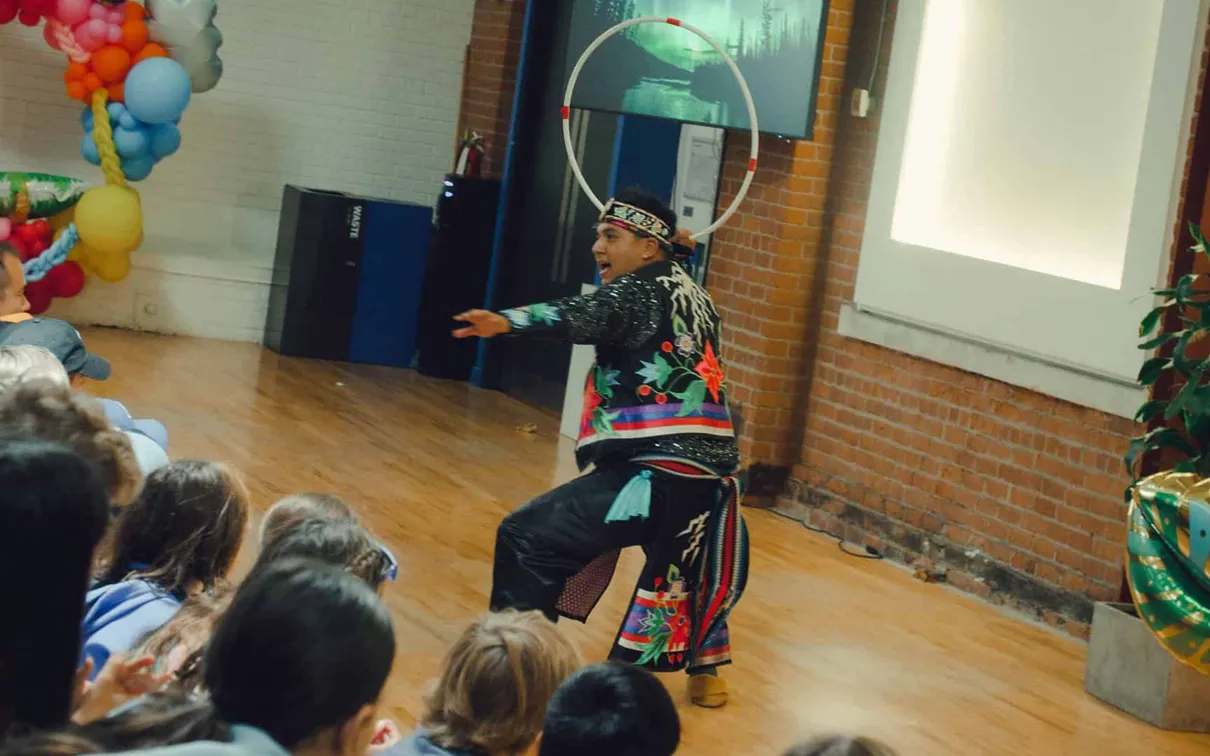 Nimkii Osawamick performing a Hoop Dance