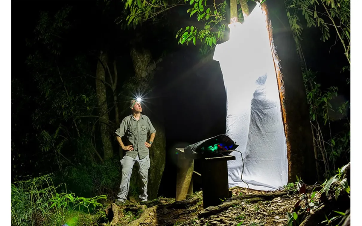 Gil Wizen standing next to an insect trap.