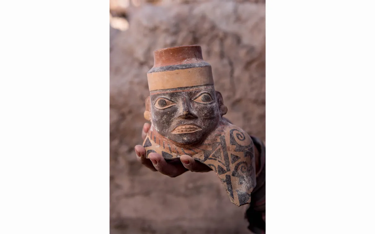 Close-up of a face-necked jar. More than 800 years before the Inca, the Wari State expanded out of the central Peruvian Sierra around 600 AD and shaped interactions in the region for the next four hundred years. Wari ceramics like this Robles Moqo face-necked jar excavated at Quilcapampa can be found across much of Peru.