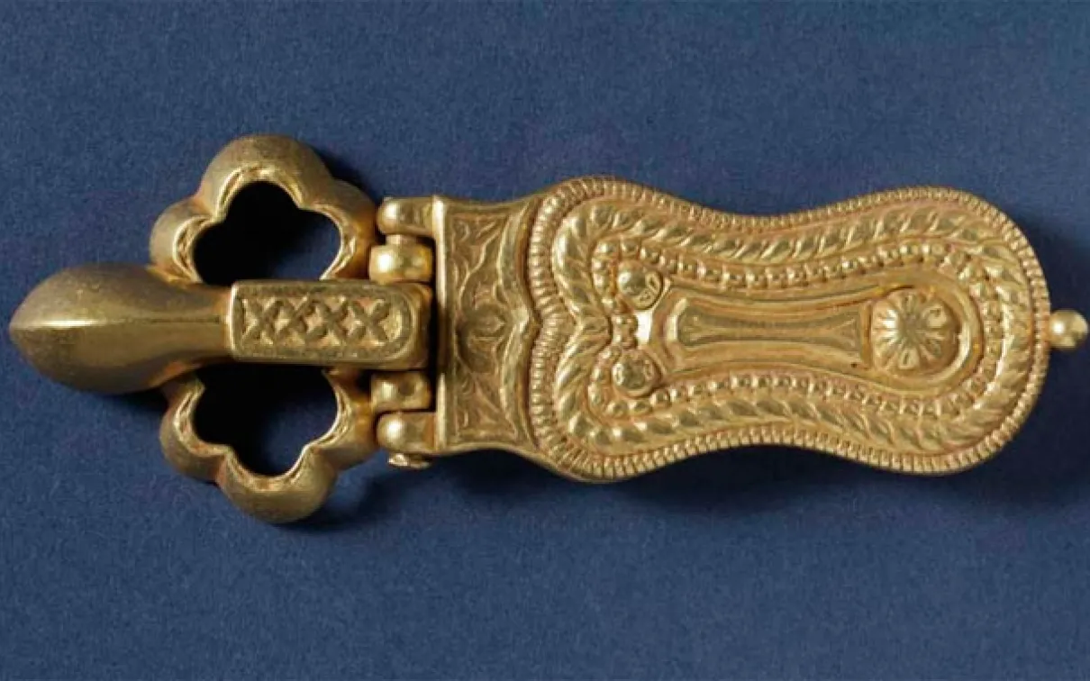 Ornate jewelry and church frescoes are showcased, such as this 7th century gold belt buckle.