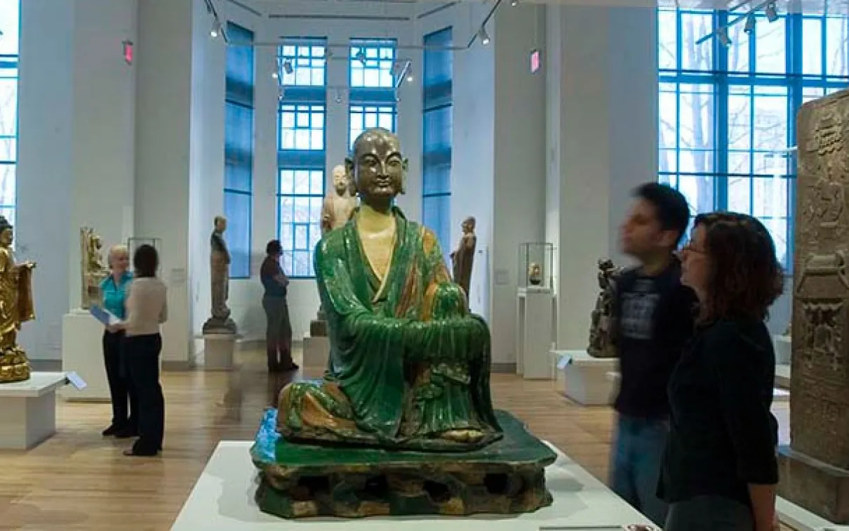 A green glazed ceramic Yizhou Luohan statue from the 10th century sits serenely at the gallery's entrance.