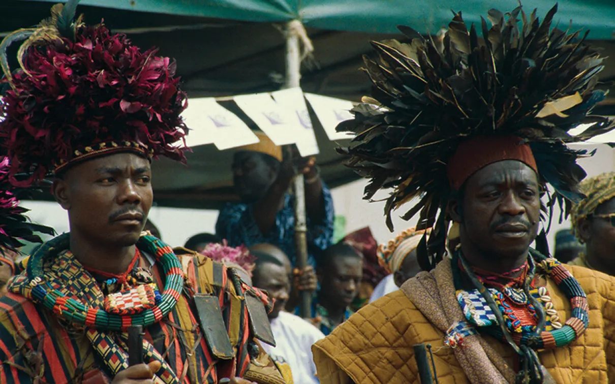 Warriors wearing ceremonial feather headdresses.