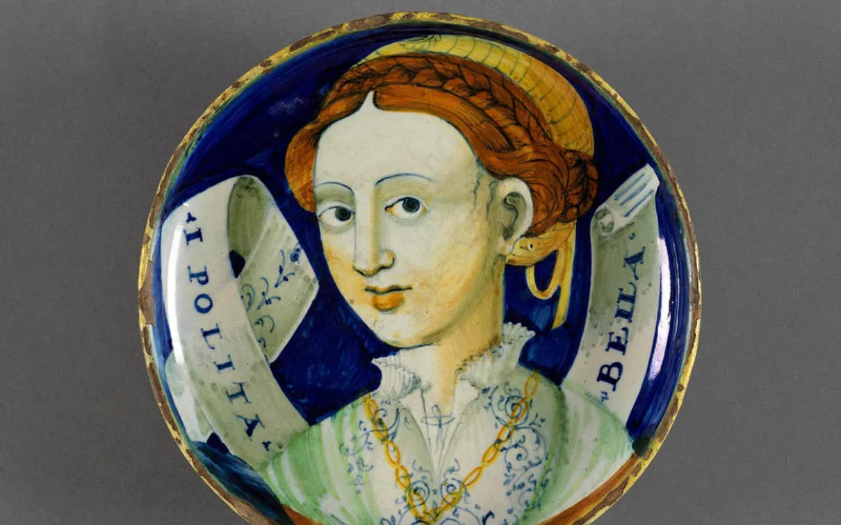 Italian pottery plate with a woman painted on it.